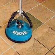 Machine cleaning grout on tile